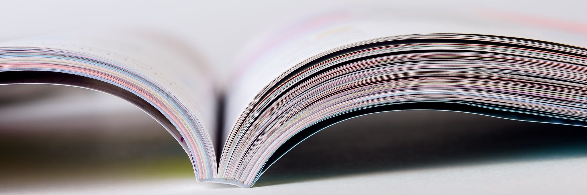 Colorful pages of an open magazine, close up. Selective focus.