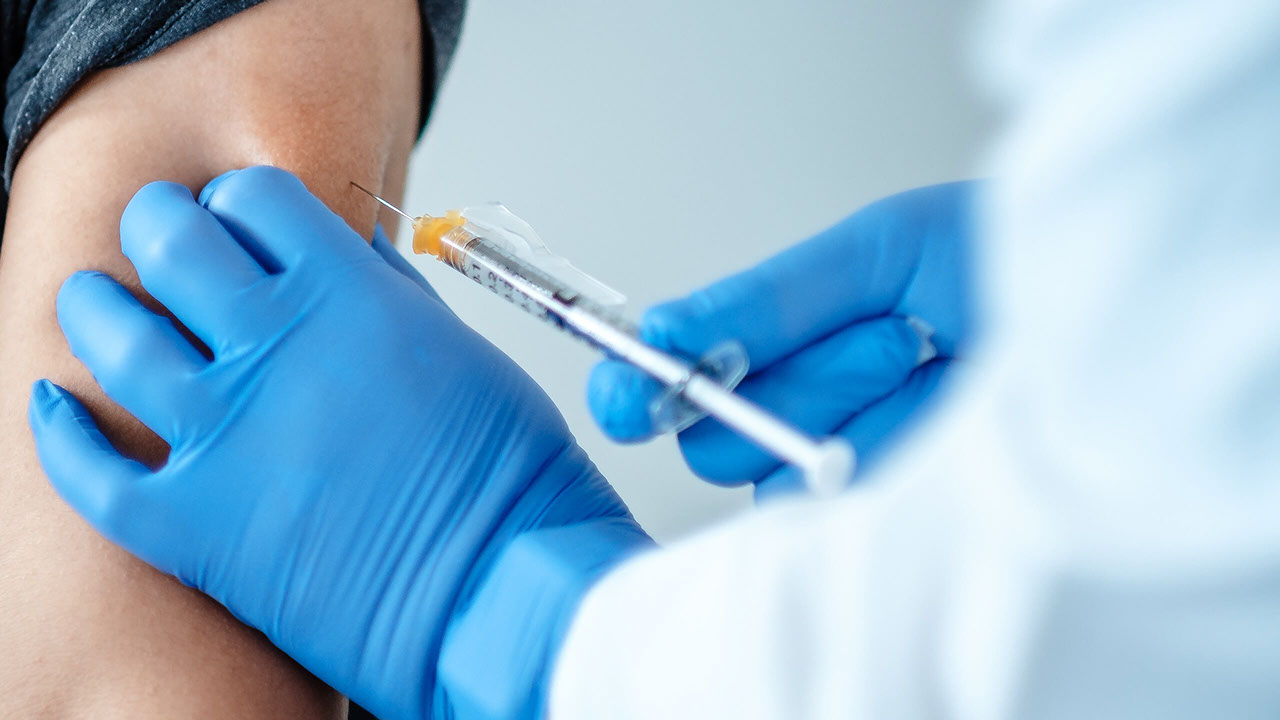 Doctor sets a vaccine syringe